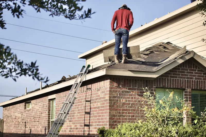 Professional roofer working on a residential roof in American Venice